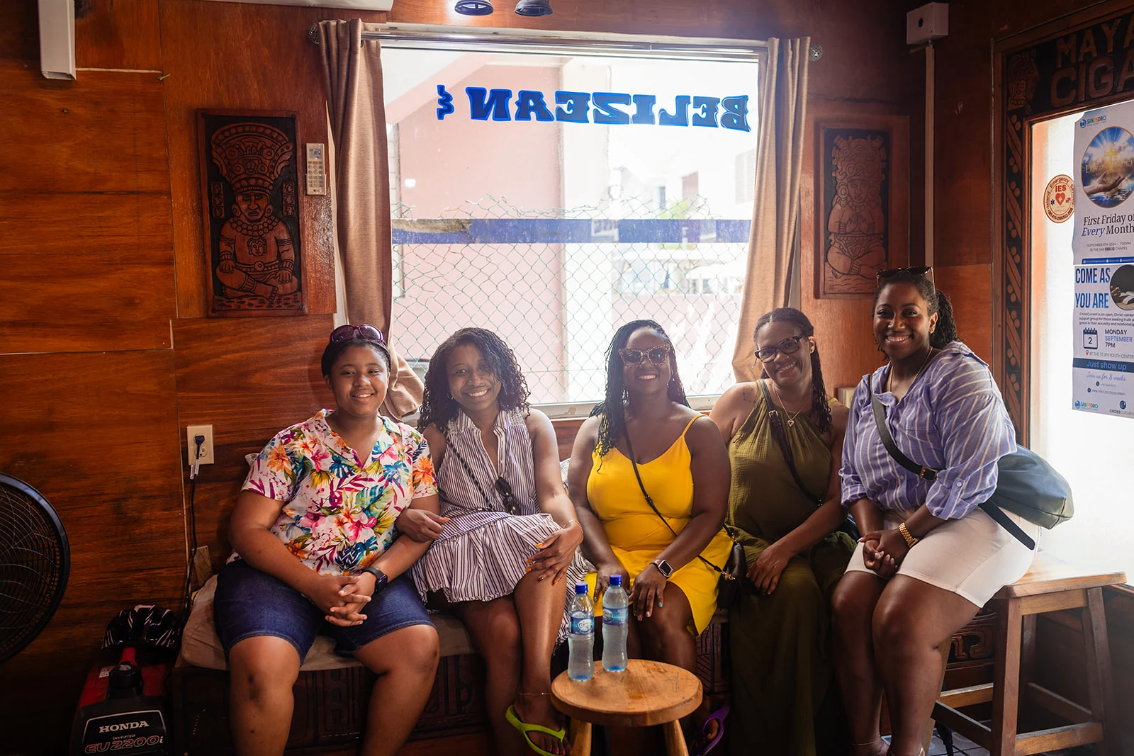 Happy guests seated together during a Belize Food Tours stop